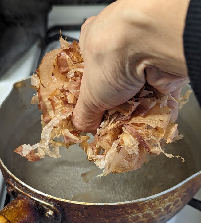 Turn off heat and add dried bonito flakes.